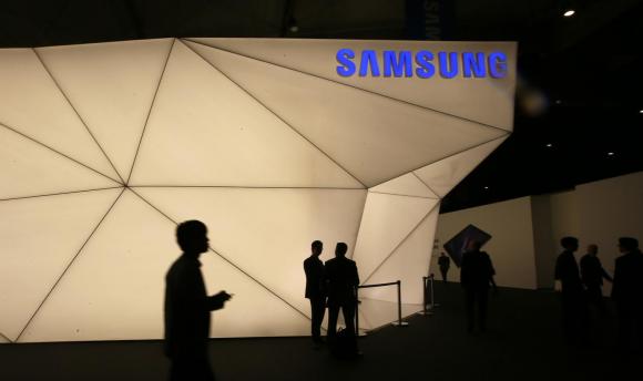 Visitors walk past the Samsung stand at the Mobile World Congress in Barcelona