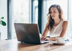 Woman using laptop while sitting at home